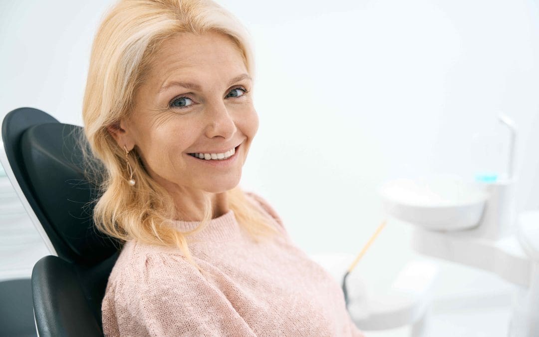 Dentist explaining how long dental bonding lasts to a patient at One Stop Dental in Colorado Springs, CO. Call 719-447-1199 for more information.